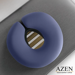 Blue massage pillow on a gray surface, branded 'AZEN'.