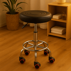 Black swivel stool with wheels in a room with plants and a shelf.