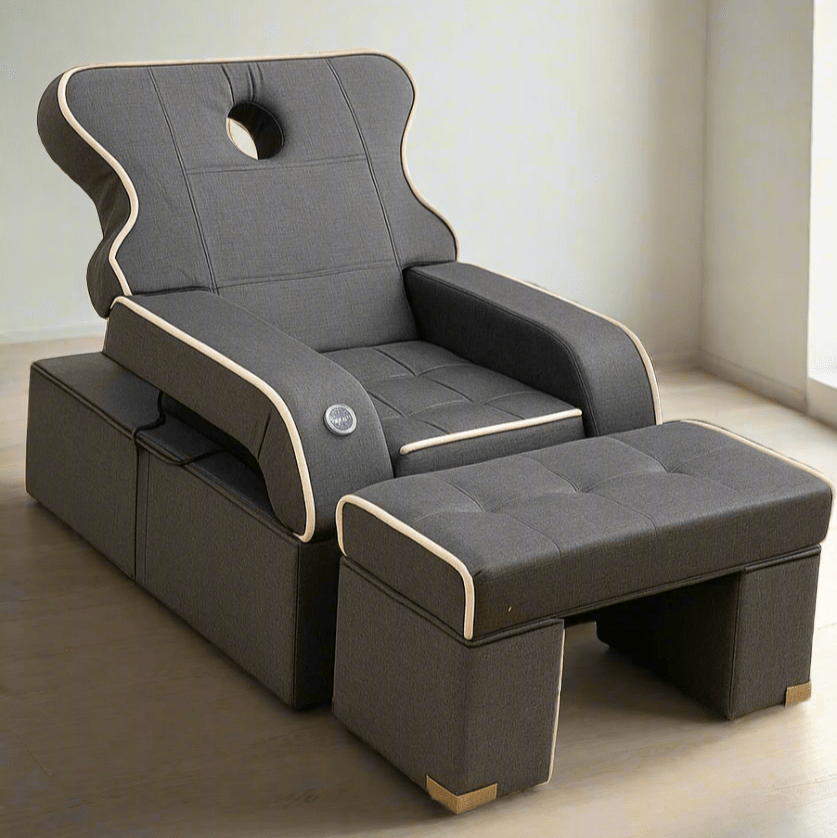 Two gray recliner chairs with ottomans on a beige carpet