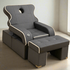 Two gray recliner chairs with ottomans on a beige carpet