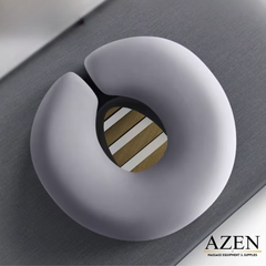 Gray U-shaped massage pillow with wooden center on a dark surface, branded 'AZEN'.